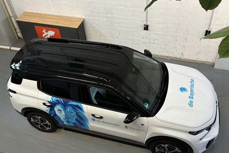 Fahrzeug von die Bayerische mit grafischer Gestaltung und schwarzem Dach, von oben aufgenommen.