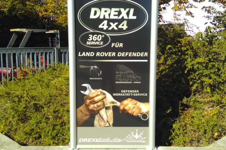 Werbeschild für DREXL 4x4 Service, spezialisiert auf Land Rover Defender Wartung und Reparatur.